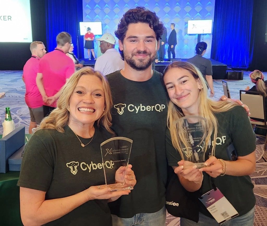 CyberQP colleagues posing for photo with awards at XChange conference